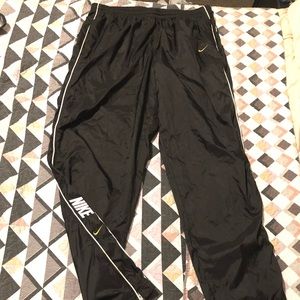 Thin Black Nike Sweatpants. Slight tore